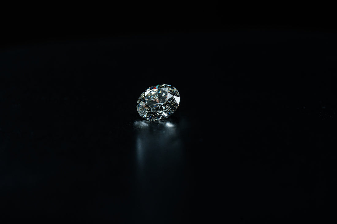 A shiny diamond is displayed on a black background.