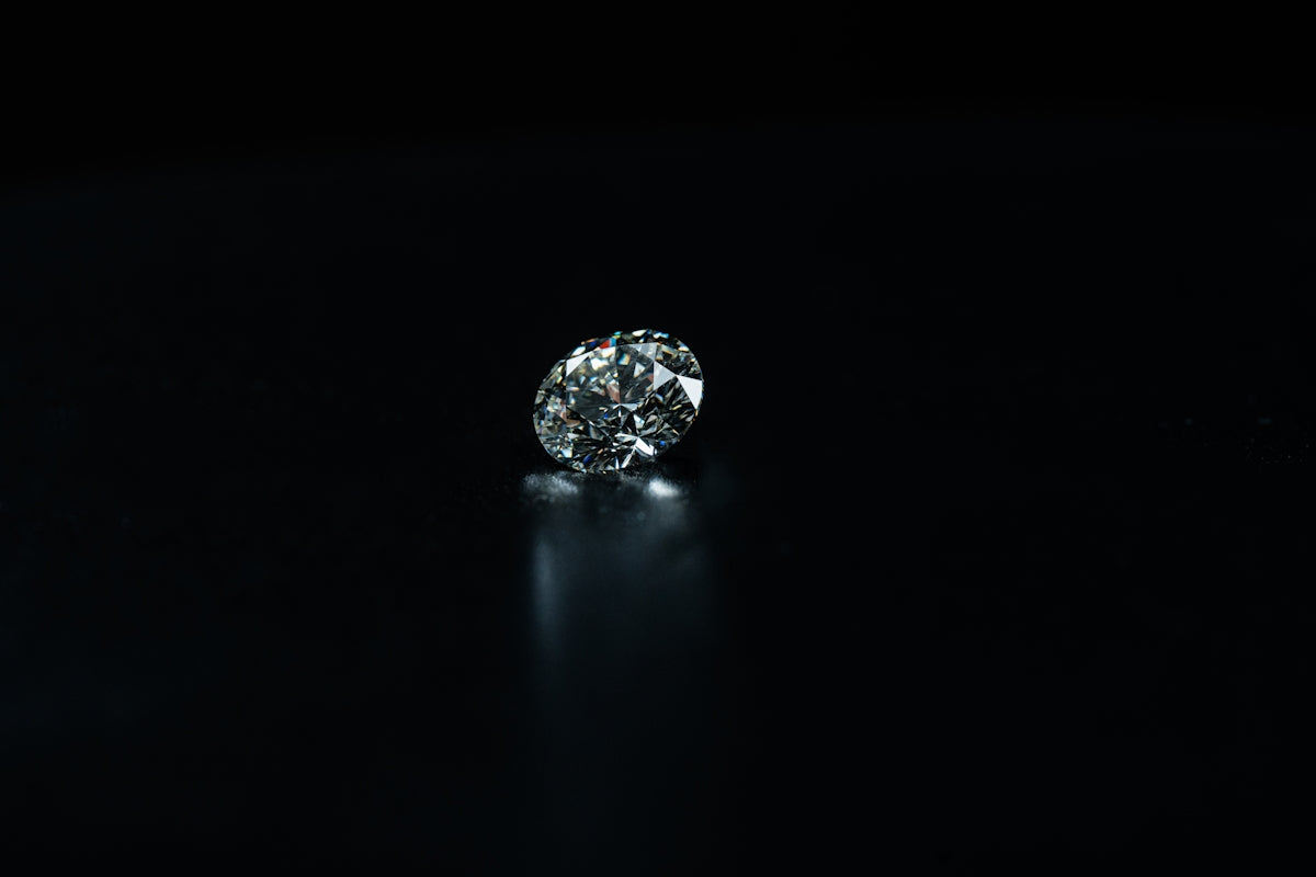 A shiny diamond is displayed on a black background.