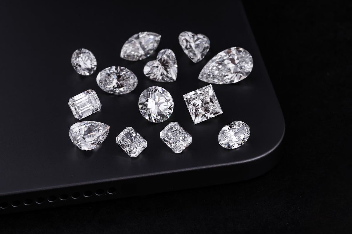 Diamonds of various shapes are on a black surface.